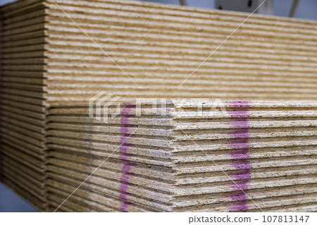 stacks of tongue and groove water resistant OSB compressed sawdust sheets 107813147