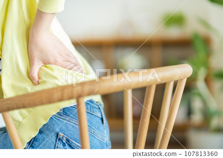 Women suffering from low back pain 107813360