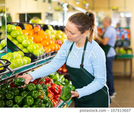 female seller selling peppers 107813607