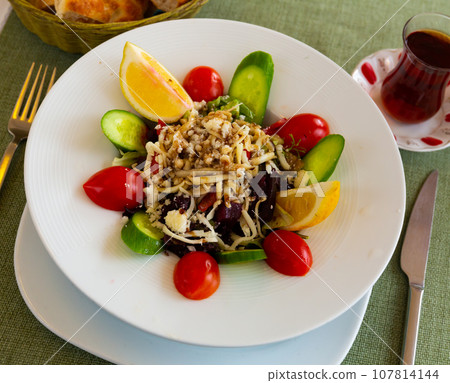 Fresh salad served on plate in restaurant Fresh salad served on plate in restaurant 107814144