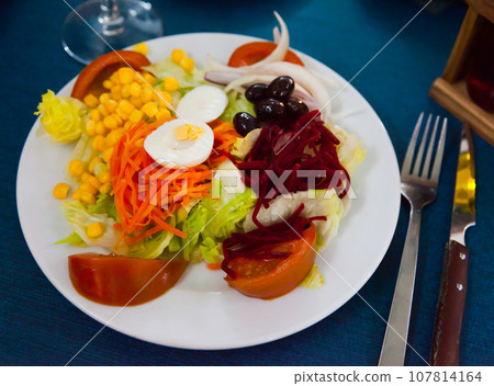 Mix salad with vegetables, prune, boiled beet and lettuce Mix salad with vegetables, prune, boiled beet and lettuce 107814164
