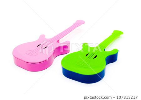 Toy guitar on white background with selective focus 107815217