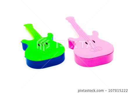 Toy guitar on white background with selective focus 107815222