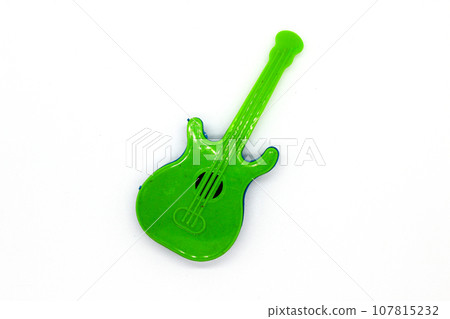 Toy guitar on white background with selective focus Toy guitar on white background with selective focus 107815232