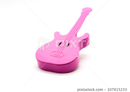Toy guitar on white background with selective focus Toy guitar on white background with selective focus 107815233