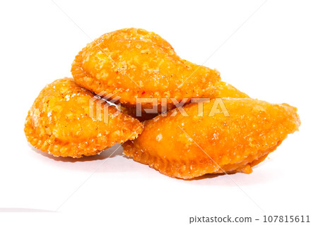 Gujiya on white background with selective focus Gujiya on white background with selective focus 107815611