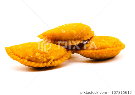 Gujiya on white background with selective focus Gujiya on white background with selective focus 107815613