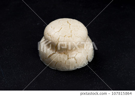 Kagami biraki cracked kagami mochi on black background Kagami biraki cracked kagami mochi on black background 107815864