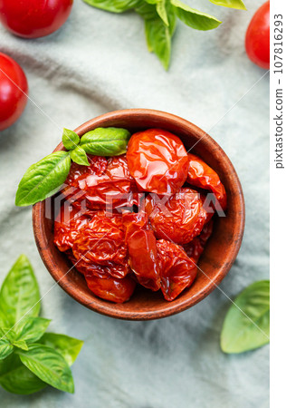 Bowl with sun dried tomatoes with fresh herbs and spices. Bowl with sun dried tomatoes with fresh herbs and spices. 107816293