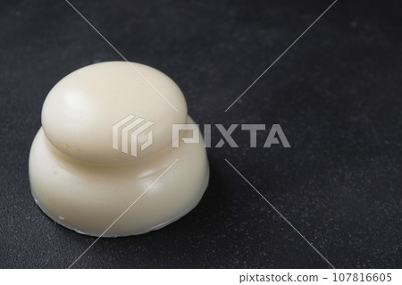 Kagami mochi on black background with copy space Kagami mochi on black background with copy space 107816605