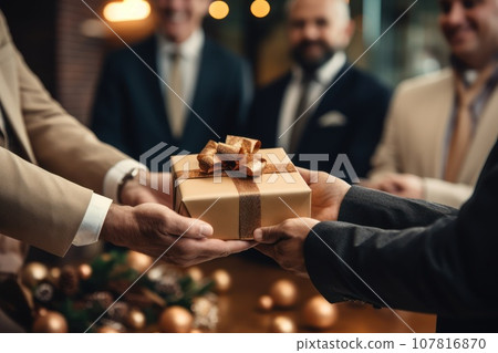 Close-up view of hands Giving a business gift in an office Close-up view of hands Giving a business gift in an office 107816870