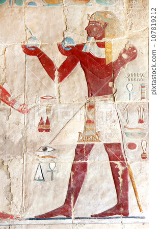 Ancient Colorful Mural Wall Painting inside Hatshepsut Temple in Valley of the Kings, Luxor, Egypt. Figure of pharaoh making ritual offerings, wall of the Hatshepsut temple in Western Thebes 107819212