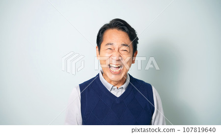 Middle-aged man laughing out loud Middle-aged man laughing out loud 107819640