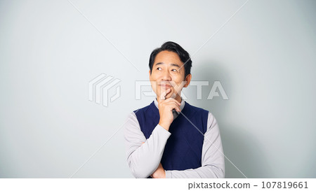 Middle-aged man thinking happily 107819661