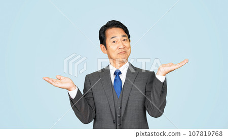 Middle-aged businessman raising his hands Middle-aged businessman raising his hands 107819768