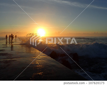 Embankment and sunrise at high tide 107820173