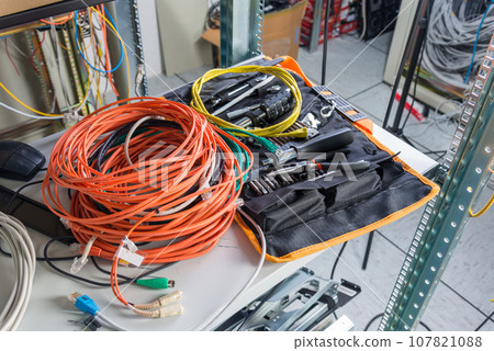 spool of fiber optic cable wiht IT engineer tools 107821088