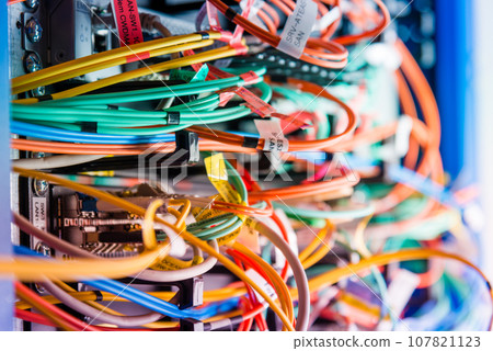 detail of server rack with fiber optic cables attached to front panel switch ports detail of server rack with fiber optic cables attached to front panel switch ports 107821123