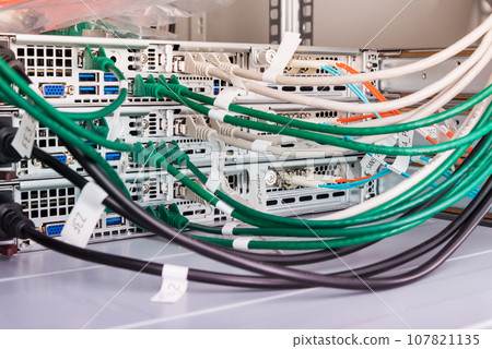 fiber optic cables connected to optic ports, network cables connected to ethernet ports fiber optic cables connected to optic ports, network cables connected to ethernet ports 107821135