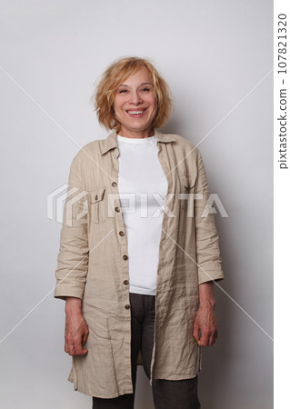 Middle age beautiful woman wearing casual jacket standing over white background Middle age beautiful woman wearing casual jacket standing over white background 107821320