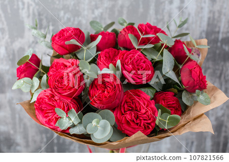Small Beautiful bouquet of mixed flowers in woman hand. Floral shop concept . Beautiful fresh cut bouquet. Flowers delivery Small Beautiful bouquet of mixed flowers in woman hand. Floral shop concept . Beautiful fresh cut bouquet. Flowers delivery 107821566