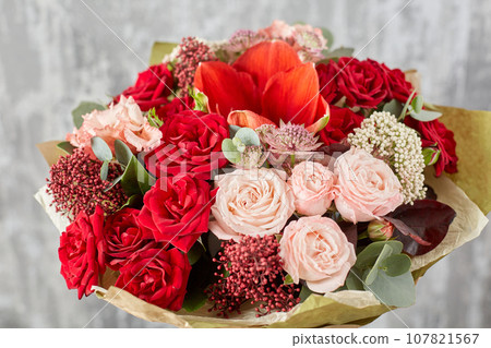 Small Beautiful bouquet of mixed flowers in woman hand. Floral shop concept . Beautiful fresh cut bouquet. Flowers delivery Small Beautiful bouquet of mixed flowers in woman hand. Floral shop concept . Beautiful fresh cut bouquet. Flowers delivery 107821567