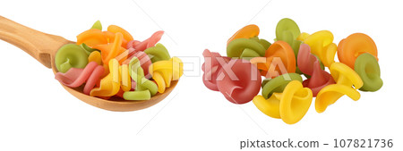 Raw colored pasta in wooden spoon isolated on white background with full depth of field 107821736