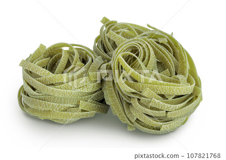 Raw tagliatelle green pasta with spinach isolated on white background 107821768