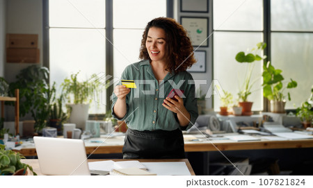 Woman is doing online purchases 107821824