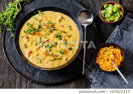 Beer cheese soup with vegetables and thyme 107822217