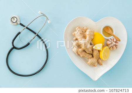Natural immune system boosters - lemon, ginger, garlic, honey and drugs, thermometer, stethoscope Natural immune system boosters - lemon, ginger, garlic, honey and drugs, thermometer, stethoscope 107824713