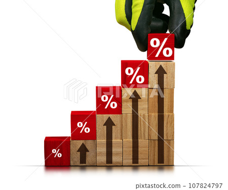 Gloved Hand Arranging Wood Blocks with Percentage Signs 107824797
