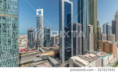 Panorama showing aerial view of Dubai International Financial District with many skyscrapers timelapse. 107825942