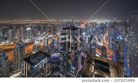 Panorama showing JBR district and Dubai Marina with JLT. Traffic between skyscrapers aerial night timelapse. Panorama showing JBR district and Dubai Marina with JLT. Traffic between skyscrapers aerial night timelapse. 107825999