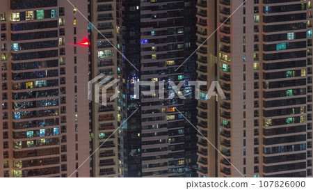Light in windows of modern towers. Exterior of apartment building at night with glowing windows timelapse. Light in windows of modern towers. Exterior of apartment building at night with glowing windows timelapse. 107826000