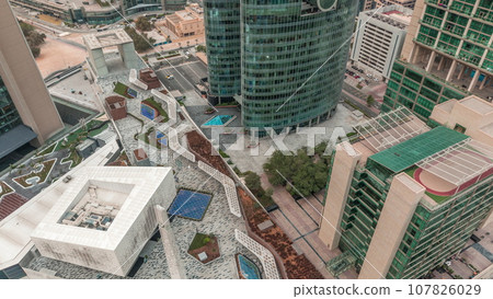 Dubai international financial center skyscrapers aerial night to day timelapse. Dubai international financial center skyscrapers aerial night to day timelapse. 107826029