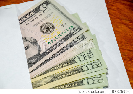 Dollars on table with an envelope. Money in an envelope. U.S. dollars. 107826904