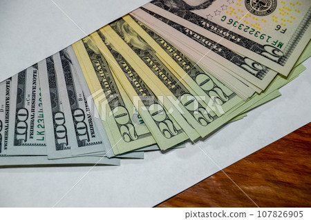 Dollars on table with an envelope. Money in an envelope. U.S. dollars. Dollars on table with an envelope. Money in an envelope. U.S. dollars. 107826905