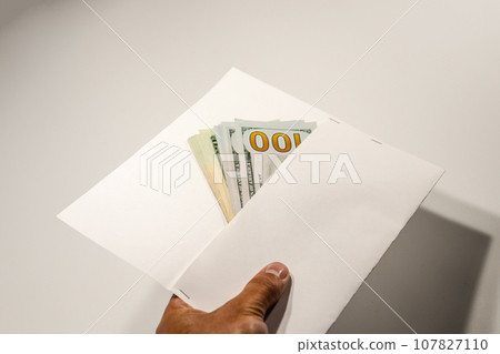 Dollars in a conwind on white background, a lot of money in an envelope. 107827110