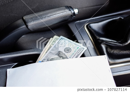 wad of dollars inside the car. wad of dollars inside the car. 107827114