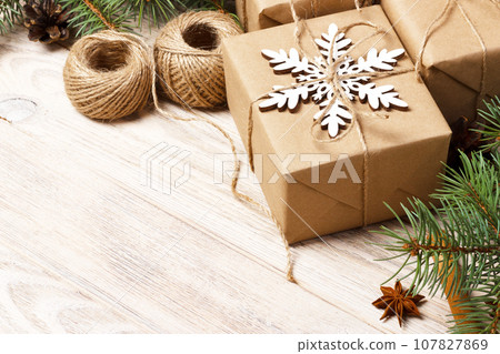 Christmas pattern with snowflake, pine cones, fir branches, christmas gift. Top view flat lay Christmas pattern with snowflake, pine cones, fir branches, christmas gift. Top view flat lay 107827869