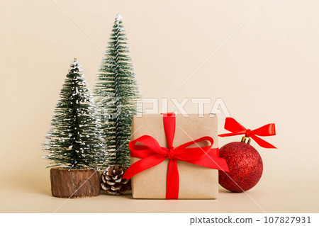Christmas composition. Gifts, small tree, branches and craft DIY decorations on white background. New year concept. Christmas home decoration Flat lay, top view, copy space Christmas composition. Gifts, small tree, branches and craft DIY decorations on white background. New year concept. Christmas home decoration Flat lay, top view, copy space 107827931