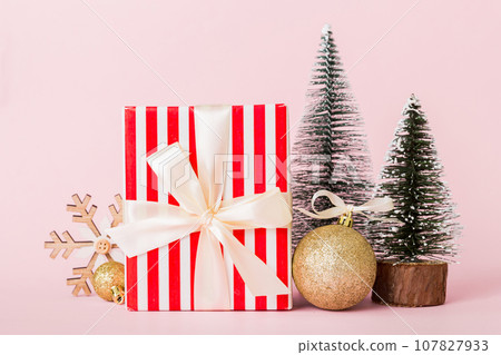 Christmas composition. craft Gift box, small tree, branches and craft DIY decorations on white background. New year concept. Christmas home decoration Flat lay, top view, copy space Christmas composition. craft Gift box, small tree, branches and craft DIY decorations on white background. New year concept. Christmas home decoration Flat lay, top view, copy space 107827933