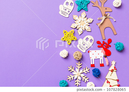 Festive decorations and toys on purple background. Merry Christmas concept with copy space 107828065