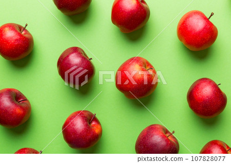 Many red apples on colored background, top view. Autumn pattern with fresh apple above view 107828077