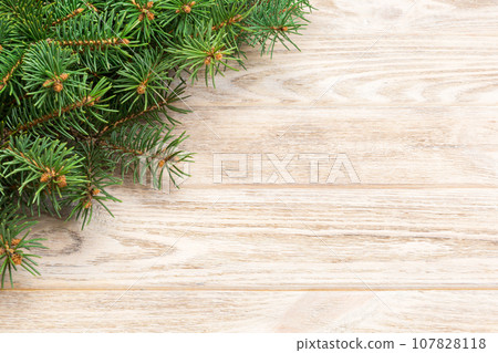 Christmas gray wooden background with fir tree and copy space. top view empty space for your design Christmas gray wooden background with fir tree and copy space. top view empty space for your design 107828118