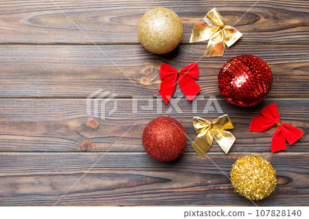 Top view of Christmas balls and creative decorations on wooden background with copy space. New Year concept Top view of Christmas balls and creative decorations on wooden background with copy space. New Year concept 107828140