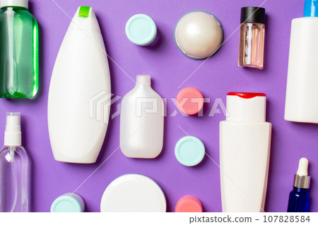 Group of plastic bodycare bottle Flat lay composition with cosmetic products on colored background empty space for you design. Set of White Cosmetic containers, top view with copy space Group of plastic bodycare bottle Flat lay composition with cosmetic products on colored background empty space for you design. Set of White Cosmetic containers, top view with copy space 107828584