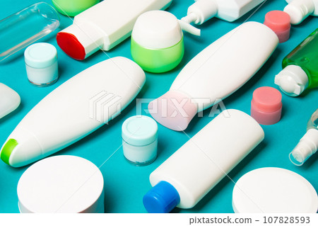 Group of plastic bodycare bottle Flat lay composition with cosmetic products on colored background empty space for you design. Set of White Cosmetic containers, top view with copy space Group of plastic bodycare bottle Flat lay composition with cosmetic products on colored background empty space for you design. Set of White Cosmetic containers, top view with copy space 107828593