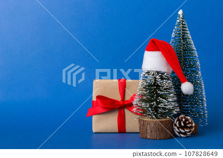 Christmas composition. craft Gift box, small tree, branches and craft DIY decorations on white background. New year concept. Christmas home decoration Flat lay, top view, copy space Christmas composition. craft Gift box, small tree, branches and craft DIY decorations on white background. New year concept. Christmas home decoration Flat lay, top view, copy space 107828649